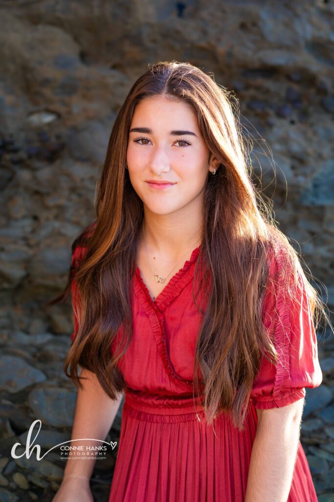 Family photos at Scripps Pier, La Jolla Beach. Stylized family with toes in sand at pier and cliffs.