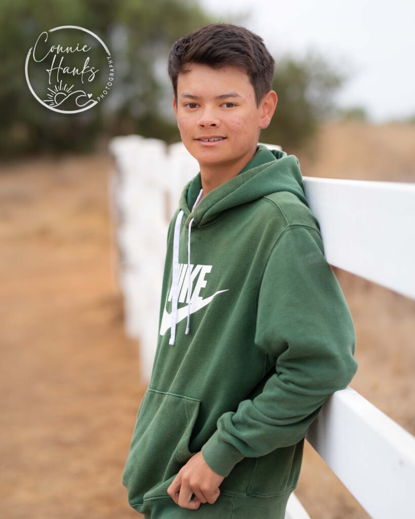 Family photos at Penasquitos Canyon, San Diego, California. Family with teens in wooded tree area, pepper trees, cactus garden, white fencing and rustic vibes.