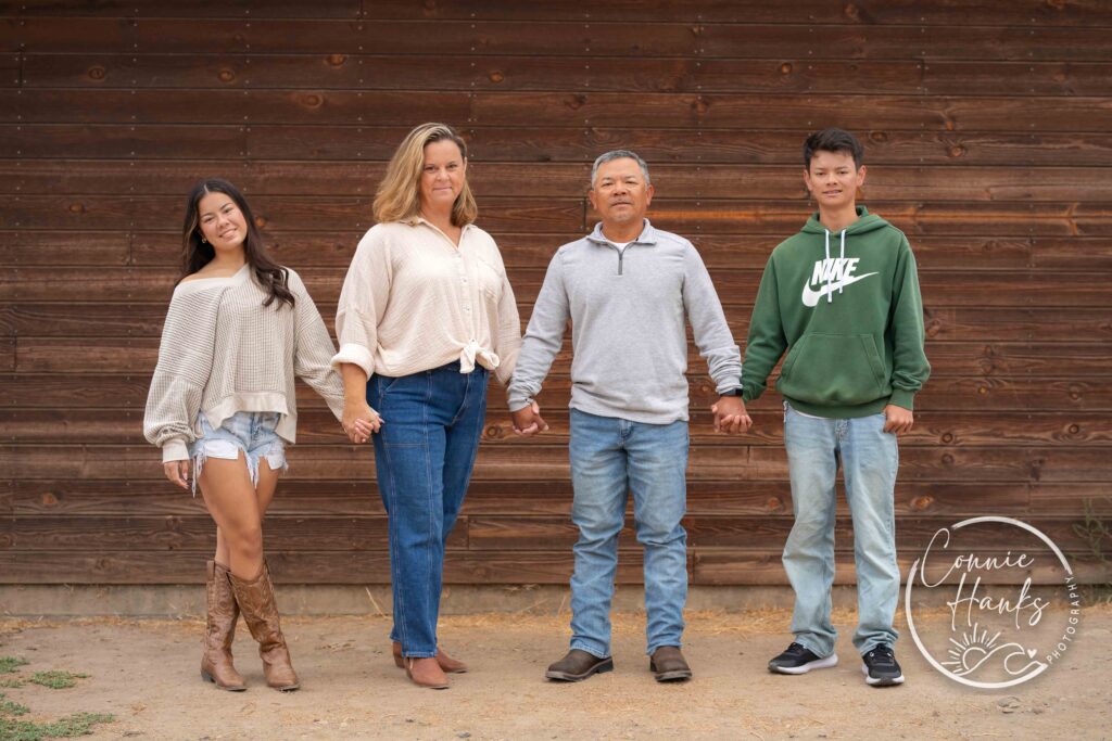 Family photos at Penasquitos Canyon, San Diego, California. Family with teens in wooded tree area, pepper trees, cactus garden, white fencing and rustic vibes.