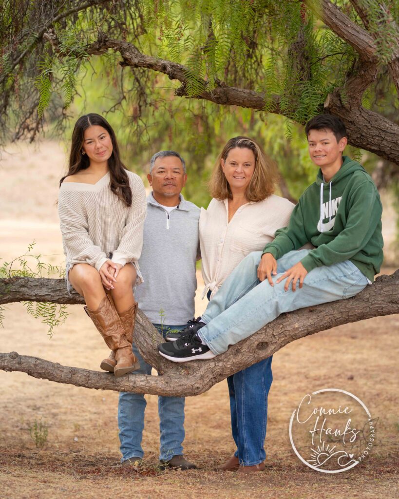 Family photos at Penasquitos Canyon, San Diego, California. Family with teens in wooded tree area, pepper trees, cactus garden, white fencing and rustic vibes.