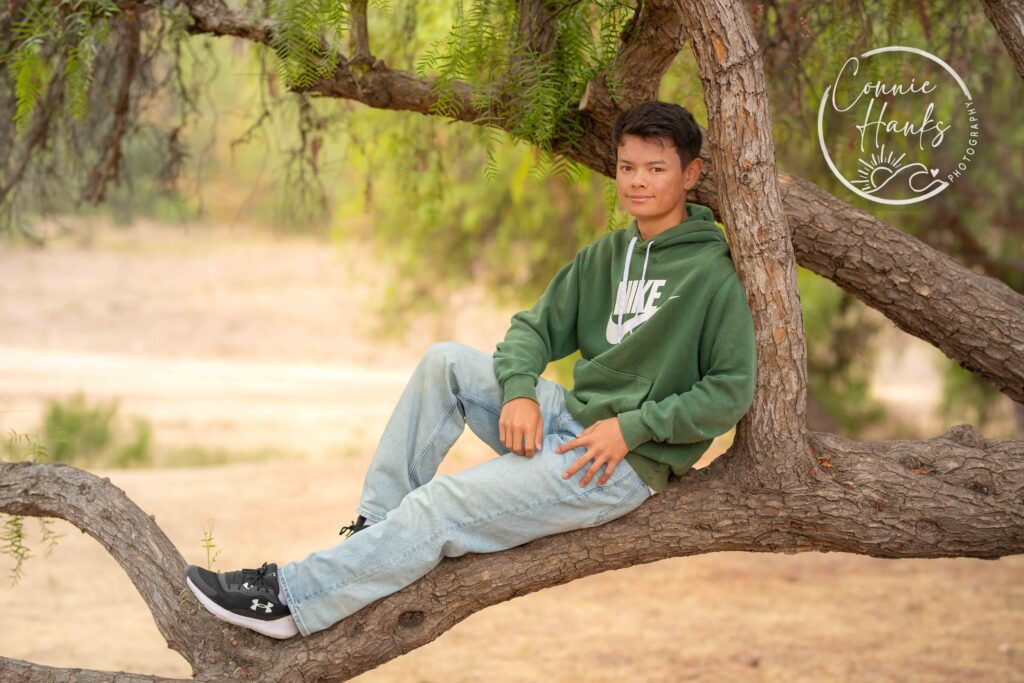 Family photos at Penasquitos Canyon, San Diego, California. Family with teens in wooded tree area, pepper trees, cactus garden, white fencing and rustic vibes.