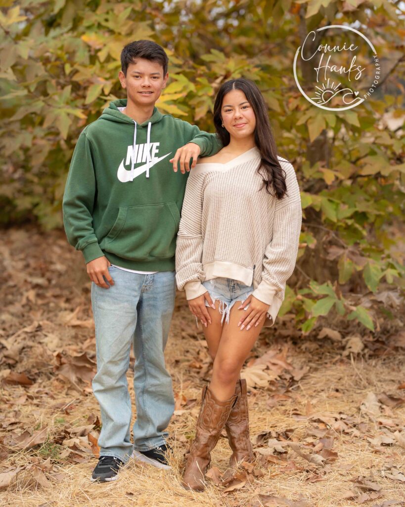 Family photos at Penasquitos Canyon, San Diego, California. Family with teens in wooded tree area, pepper trees, cactus garden, white fencing and rustic vibes.