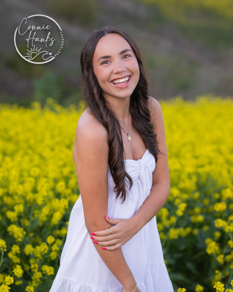 Senior photos wildflower field in Chula Vista, San Diego, California. Gorgeous girl in mustard seed wildflowers.