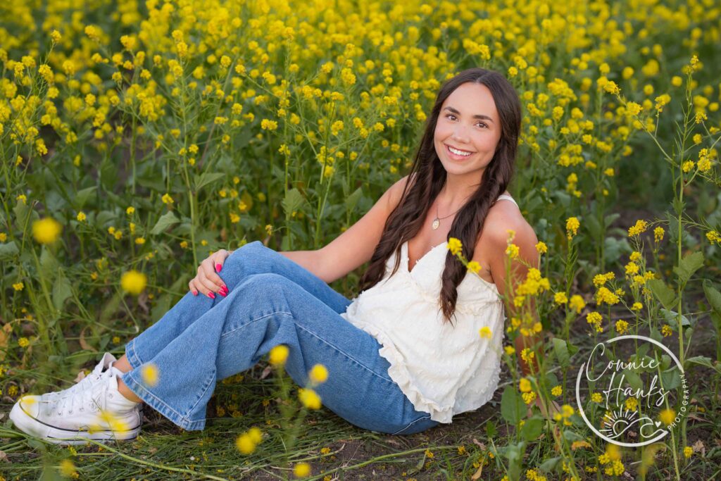 Senior photos wildflower field in Chula Vista, San Diego, California. Gorgeous girl in mustard seed wildflowers.
