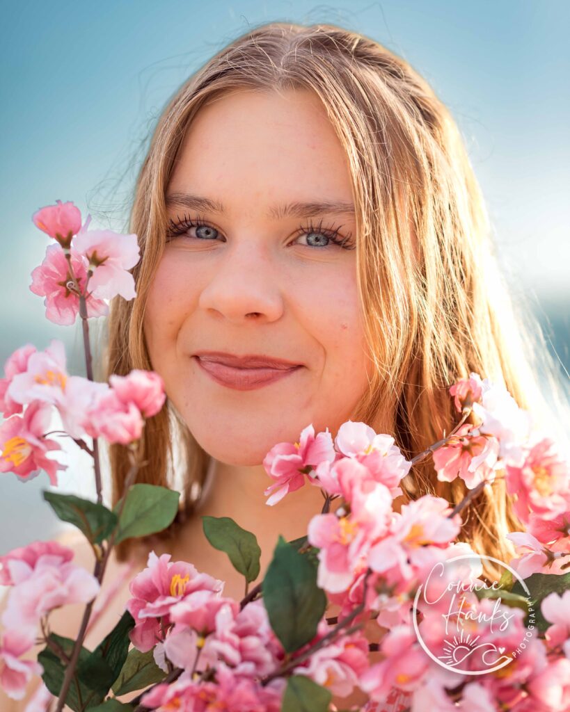 Senior photos at Coronado. Girl at beach with flower bouquet.